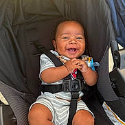 Zyrae joined the competition — help win amazing prizes! baby, baby_clothes, baby_toy, child, clothing, cute, expression, hands, happy, infant, legs, outdoor, pacifier, person, portrait, seat, seatbelt, smiling, socks, stroller