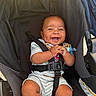 baby, baby_clothes, baby_toy, child, clothing, cute, expression, hands, happy, infant, legs, outdoor, pacifier, person, portrait, seat, seatbelt, smiling, socks, stroller