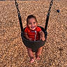 Zyrae is registered to the contest to win money with this photo: baby, barefoot, chain, child, cute, daylight, fun, happy, infant, joyful, outdoor, park, person, play, playground, red_clothing, seat, smiling, swing, wood_chips