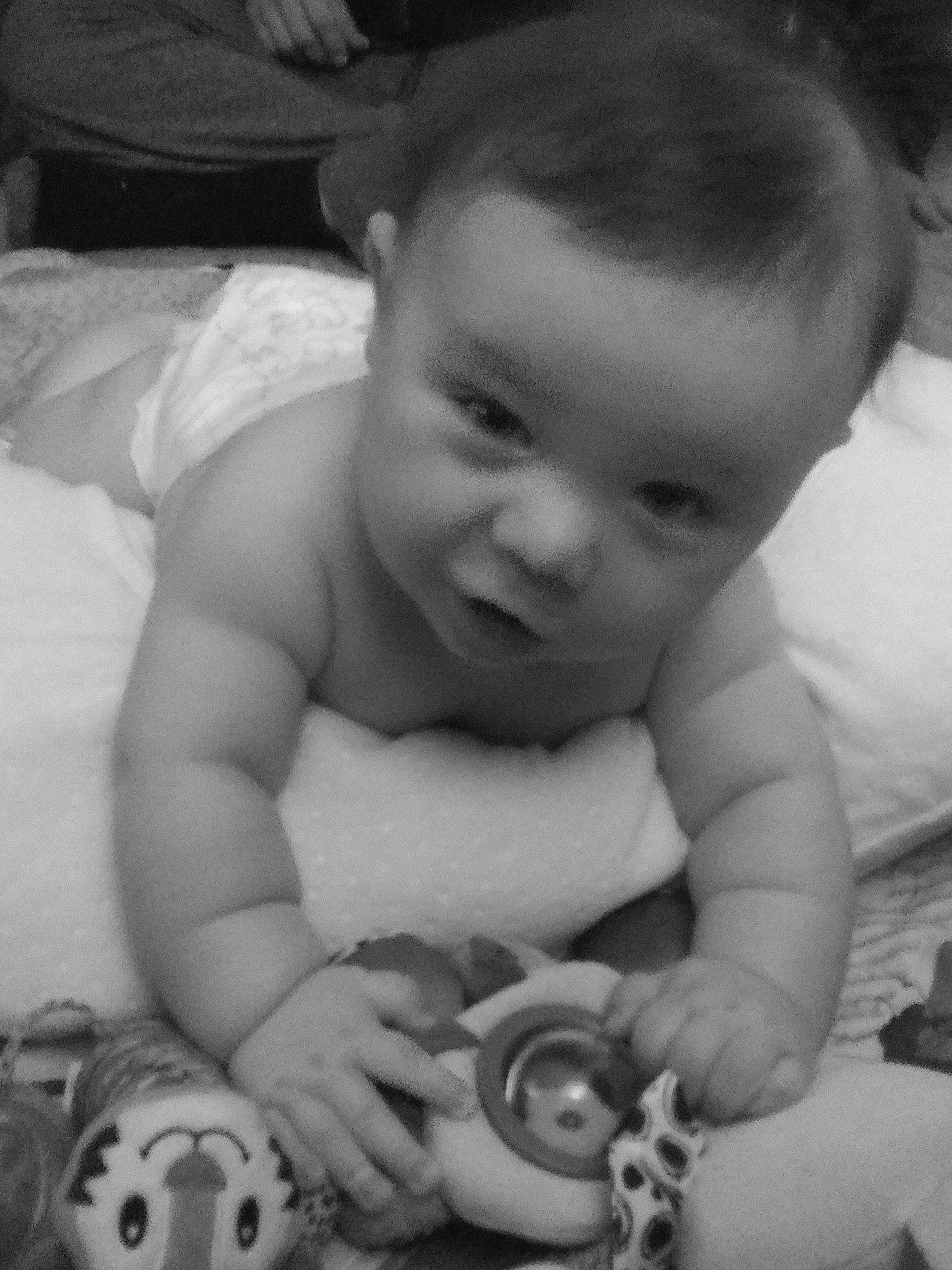 Johnathon is registered to the contest to win money with this photo: arm, baby, black, cheek, eye, eyebrow, facial_expression, finger, hand, human, human_body, iris, mammal, mouth, muscle, nose, person, photograph, skin, vertebrate