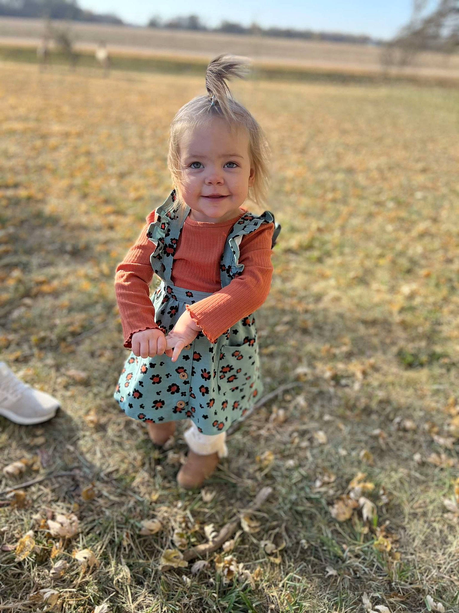 Brynlee joined the competition — help win amazing prizes! baby_toddler_clothing, blond, child, field, fun, grass, grass_family, grassland, happy, joy, landscape, natural_environment, nature, people_in_nature, person, prairie, sand, sitting, sky, smile