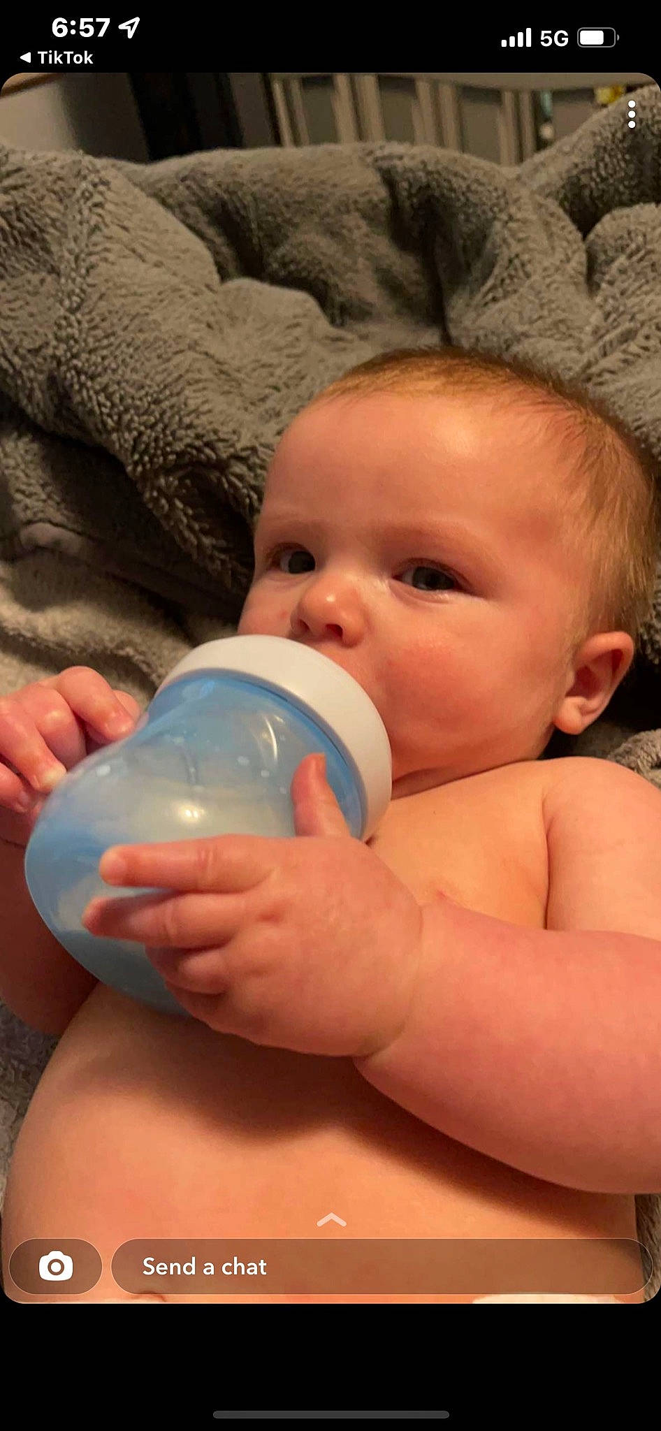Elijah is registered to the contest to win money with this photo: arm, baby, baby_bottle, bottle, cheek, comfort, drinkware, eyelash, facial_expression, finger, gesture, hand, iris, mouth, nail, nose, person, plastic_bottle, skin, thumb