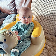 Ethan joined the competition — help win amazing prizes! baby, infant, child, pajamas, inflatable_chair, bear_design, couch, leather, cushion, blanket, blue, yellow, soft_toy, indoor, seated, cozy, cute, person, face, home
