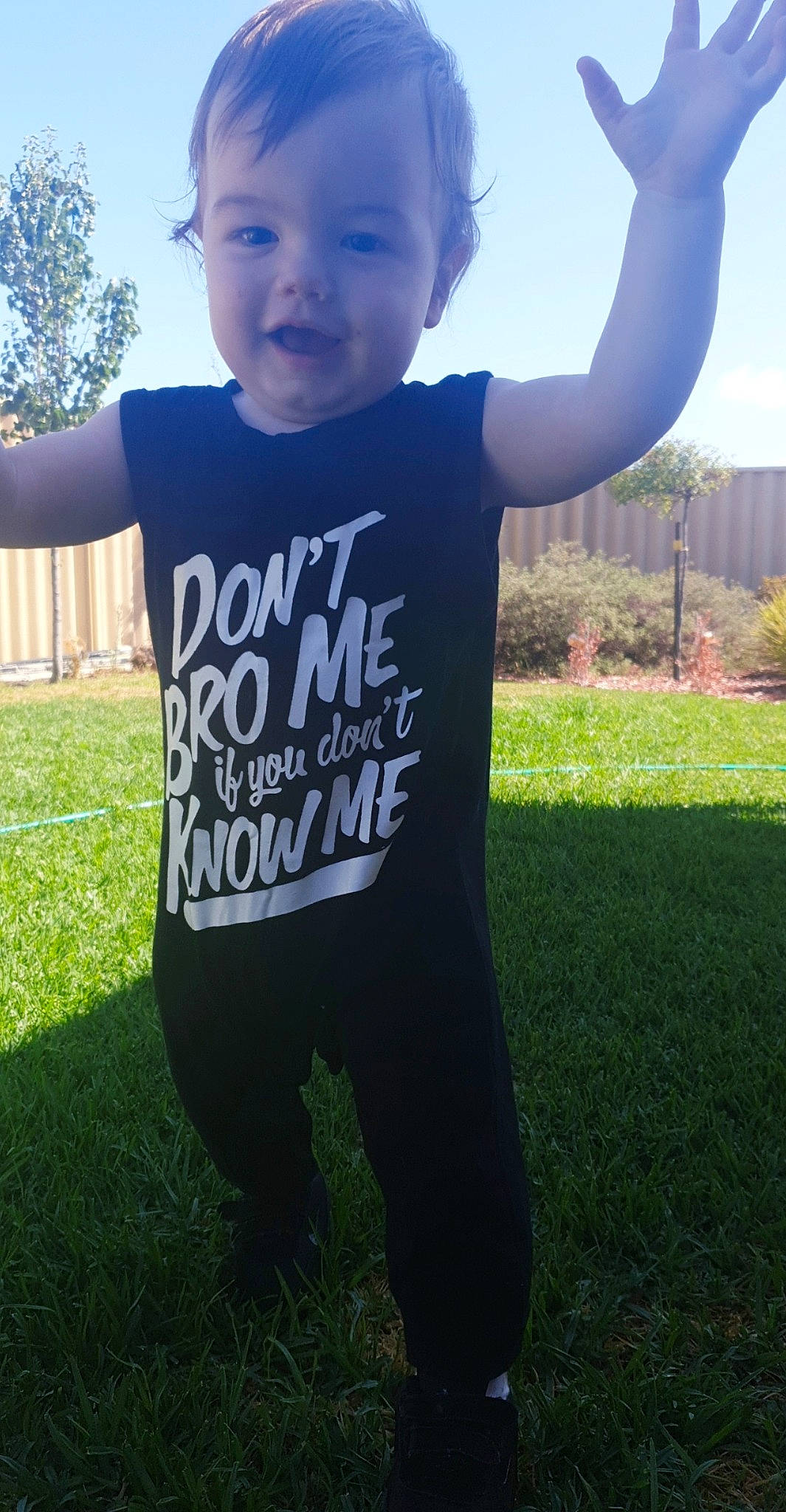 Kylar is registered to the contest to win money with this photo: child, cool, grass, happy, lawn, person, plant, sleeve, smile, t_shirt, toddler, top, tree