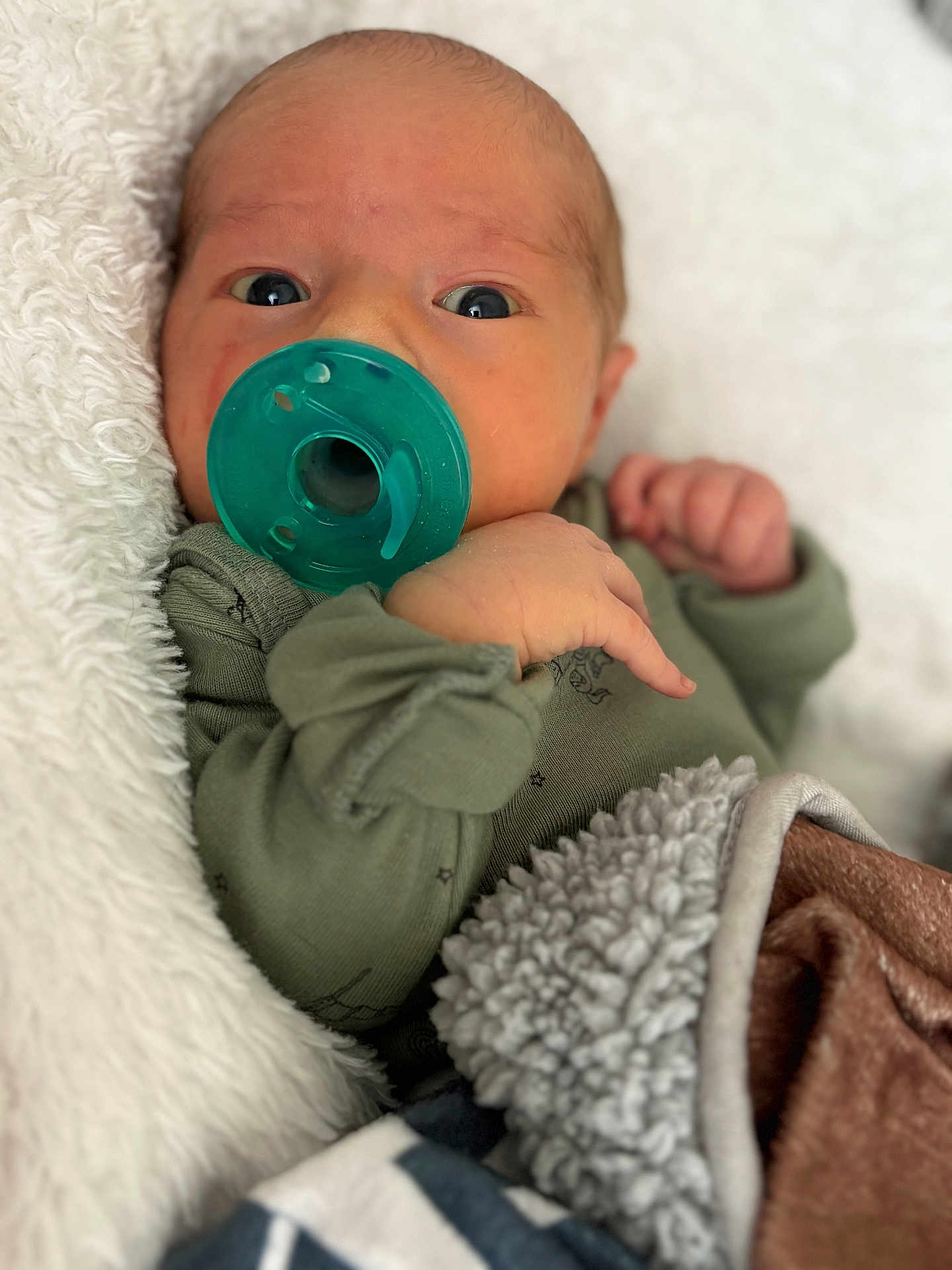 Cedrick joined the competition — help win amazing prizes! baby, newborn, pacifier, blanket, clothing, face, hand, sleepwear, infant, closeup, portrait, soft_texture, comfort, cute, child, cuddle, warm, expression, skin, lying_down