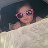 Aurora is registered to the contest to win money with this photo: baby, child, sunglasses, stroller, blanket, pink, cozy, infant, cute, face, headwear, seatbelt, clothing, person, outdoor, morning, reflection, window, soft, warm