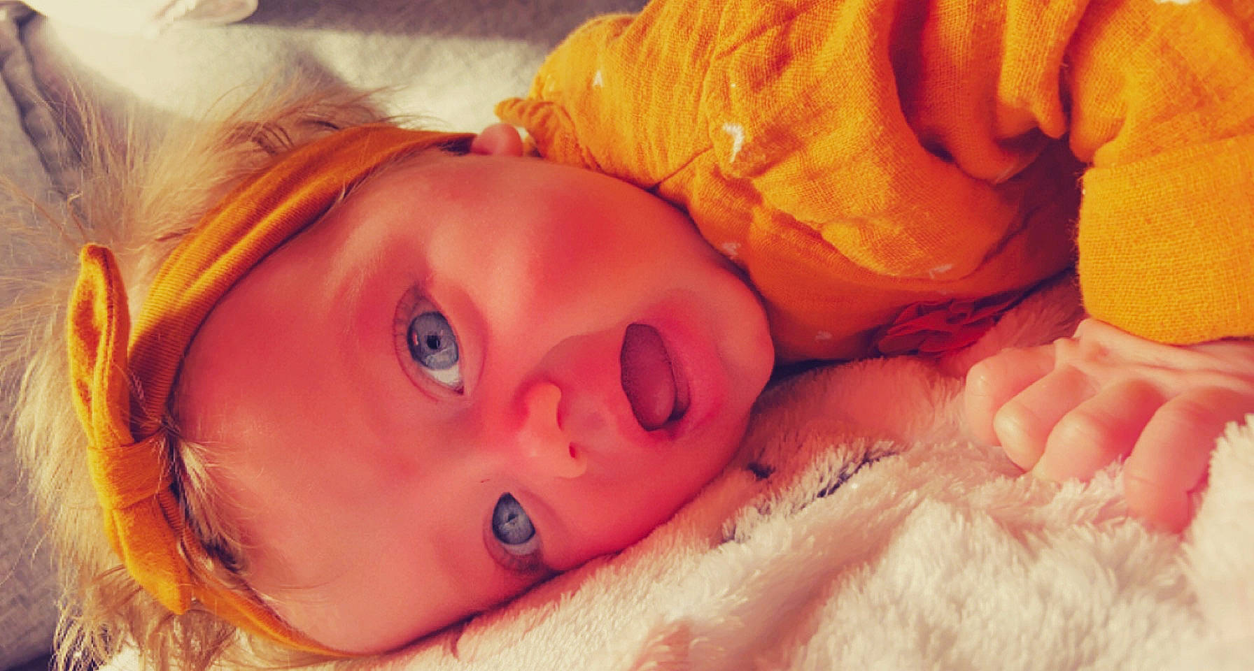 Laïna participe au concours pour gagner de l'argent avec cette photo : baby, blond, cheek, child, close_up, comfort, eyelash, grass, happy, human_body, iris, lip, mouth, muscle, nose, orange, organ, person, skin, toddler