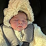 baby, child, sleeping, car_seat, car_interior, hood, fluffy_clothing, seatbelt, infant, soft_texture, face, closed_eyes, cozy, warm, young_child, transportation, car, safety, portrait, resting