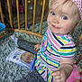 toddler, child, baby, smiling, headband, striped_clothing, blue_eyes, sitting, rug, baby_wipes, doll, wooden_baby_gate, indoor, play_area, cute, happy, colorful, soft_texture, person, young_child