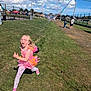 Grace joined the competition — help win amazing prizes! child, girl, running, bubble, pink_dress, fairy_costume, glasses, grass, outdoor, sunny, blue_sky, clouds, people, fence, sports_field, event, daytime, play, joyful, fun