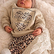 Ohana participe au concours pour gagner de l'argent avec cette photo : baby, sleeping, infant, blanket, cozy, leopard_print, clothing, headwear, soft_texture, cute, newborn, peaceful, wrapped, warm, portrait, indoor, child, resting, comfort, small
