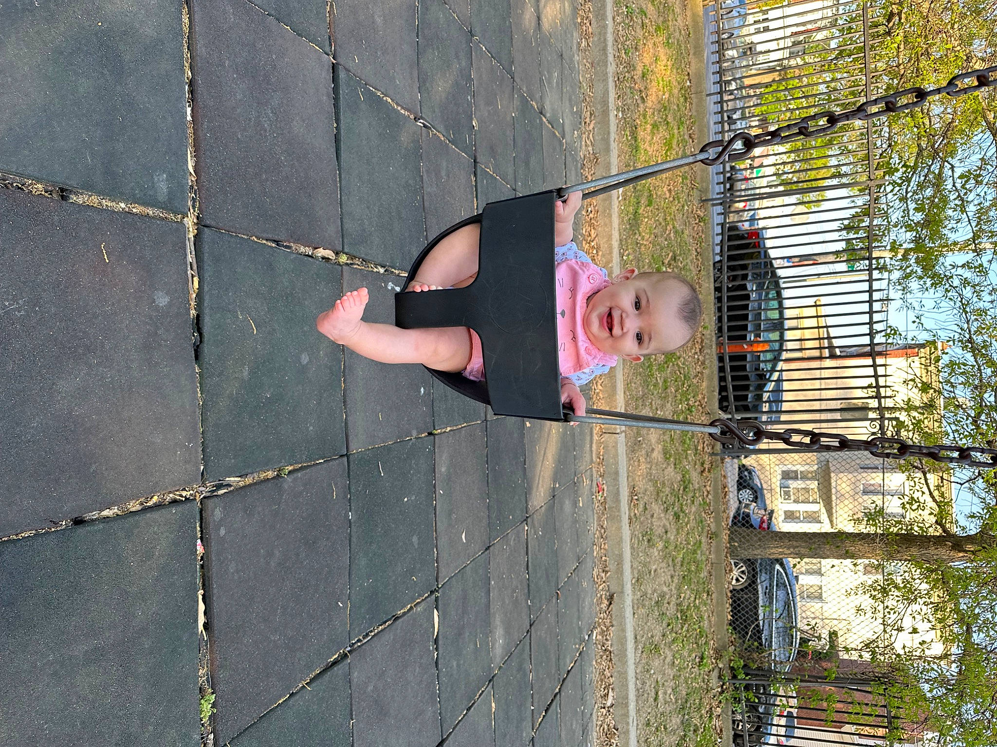 Alaina is registered to the contest to win money with this photo: asphalt, brickwork, cement, concrete, facade, flooring, human_leg, joy, leisure, pattern, person, plant, recreation, road_surface, shadow, sidewalk, thigh, toddler, tree, wall