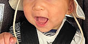 Su-Jin is registered to the contest to win money with this photo: baby, baby_bib, car_seat, child, closeup, clothing, cute, eyes, happy, hat, headwear, infant, infant_clothing, joy, mouth_open, person, safety, seatbelt, smile, straps