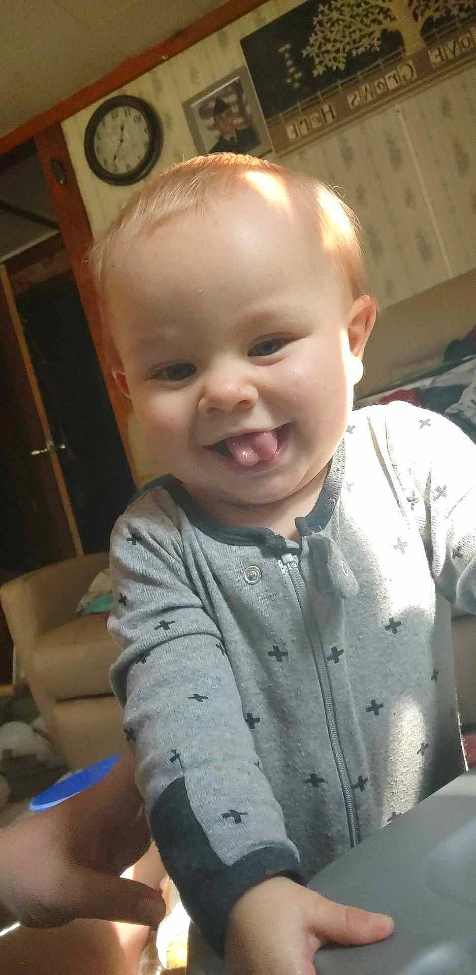 Bronson is registered to the contest to win money with this photo: baby, baby_toddler_clothing, cheek, child, chin, clock, face, fun, happy, head, human_body, iris, joy, lip, mouth, nose, person, skin, sleeve, smile