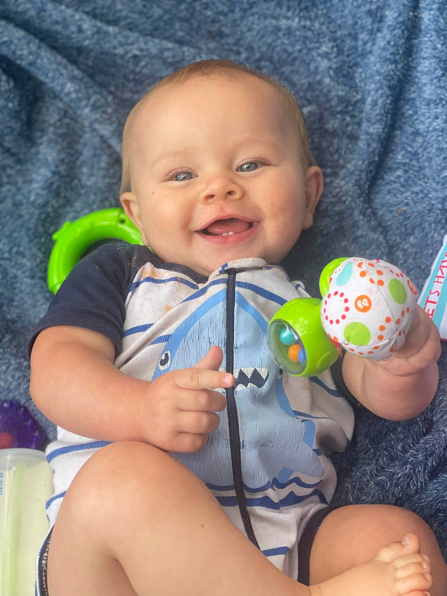 Bronson is registered to the contest to win money with this photo: baby, baby_products, baby_toddler_clothing, cheek, child, comfort, electric_blue, facial_expression, finger, fun, happy, nail, pattern, person, product, sitting, skin, smile, thigh, thumb