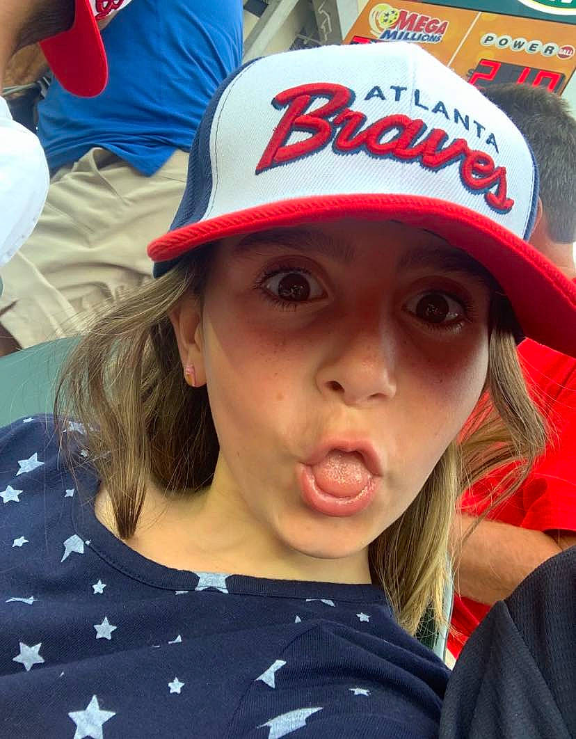 Judith is registered to the contest to win money with this photo: baseball_cap, cap, cool, cricket_cap, eye, eyelash, face, fan, fashion_accessory, fun, happy, hat, headgear, headwear, lip, mouth, person, recreation, red, t_shirt