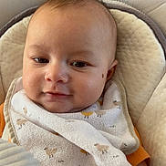 Sohan participe au concours pour gagner de l'argent avec cette photo : baby, infant, bib, toy, hand, seat, cushion, face, expression, comfort, clothing, child, cute, indoors, portrait, skin, head, smile, person, young