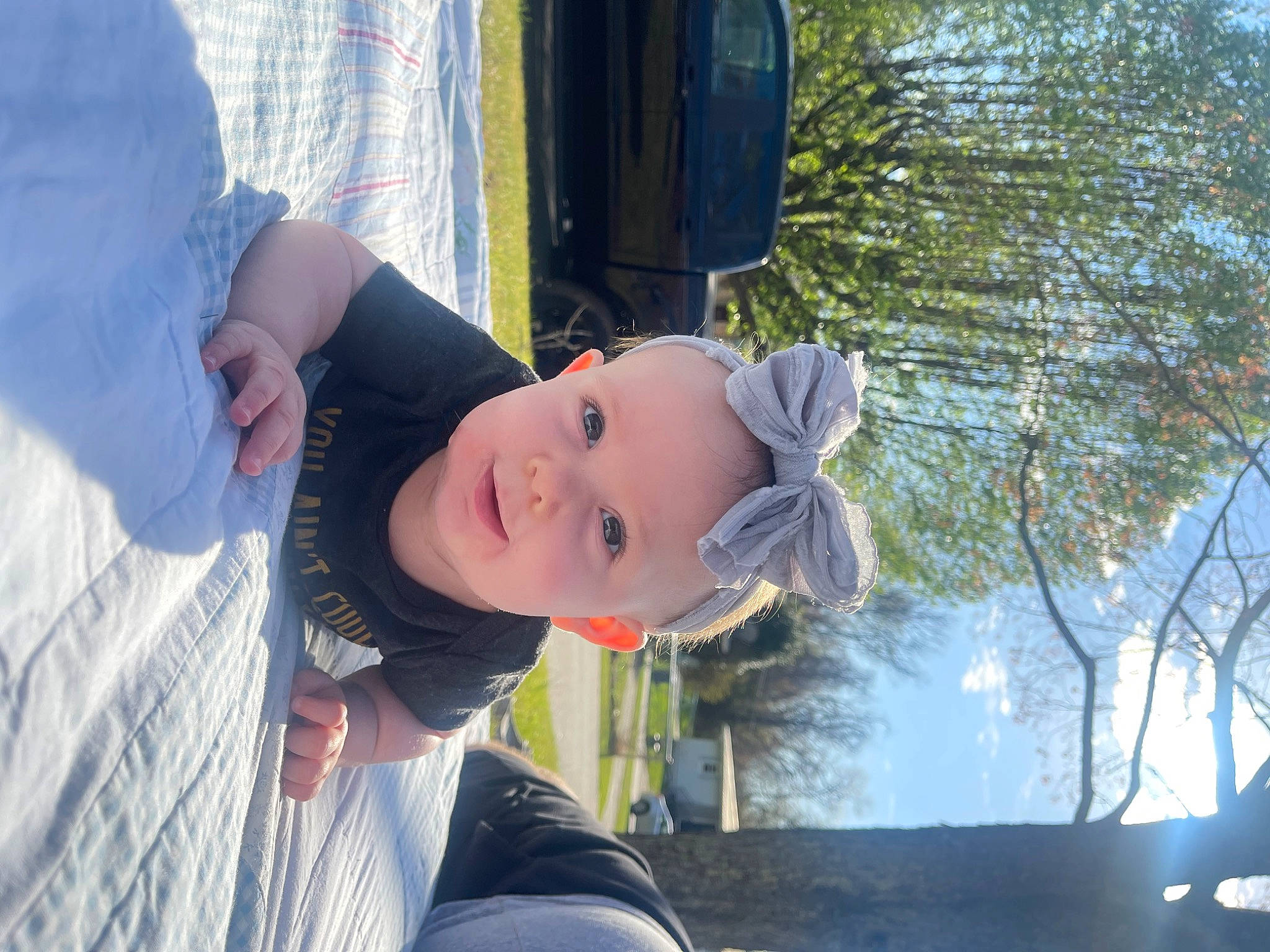 Calliope is registered to the contest to win money with this photo: baby, child, freezing, fun, grass, happy, hat, leisure, person, plant, recreation, sitting, smile, snow, toddler, tree, water, window, winter