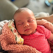 Ayla is registered to the contest to win money with this photo: baby, newborn, sleeping, blanket, pink, floral, pillow, soft, cute, peaceful, infant, face, clothing, closeup, portrait, indoors, person, relaxing, resting, cozy