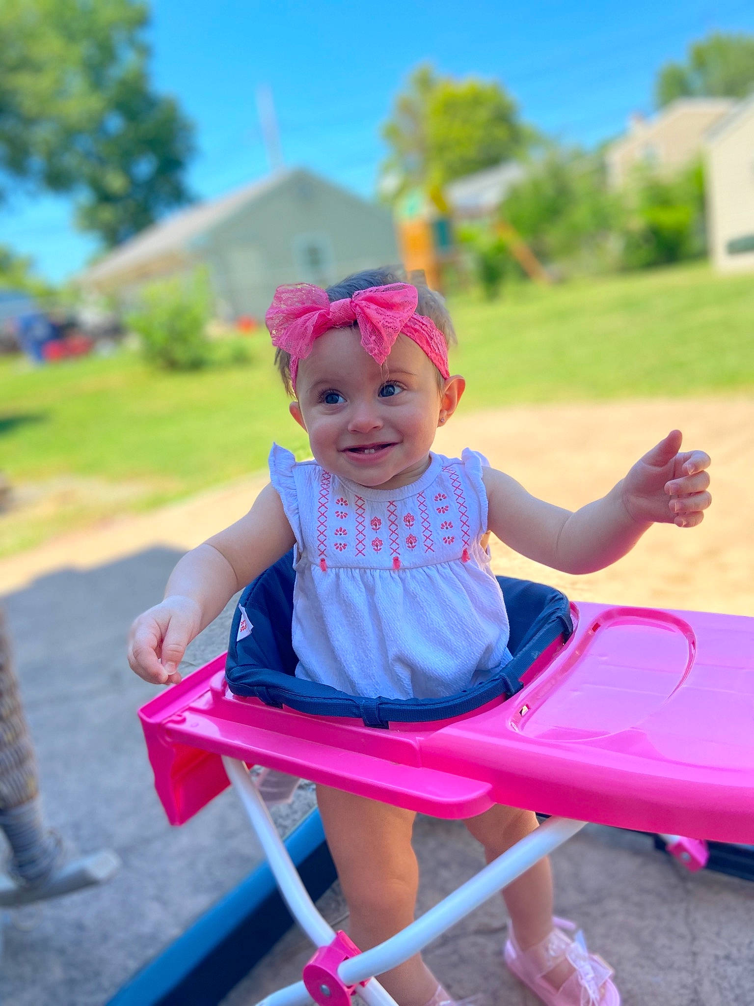 Hazel is registered to the contest to win money with this photo: baby, child, costume, dress, fun, headwear, joy, leisure, magenta, person, pink, plant, play, playground, public_space, recreation, sitting, skin, smile, summer