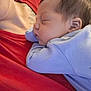 Xylena is registered to the contest to win money with this photo: baby, sleeping, infant, child, person, closeup, face, skin, hair, clothing, red_shirt, blue_outfit, resting, peaceful, cuddle, portrait, young, indoors, human, comfort