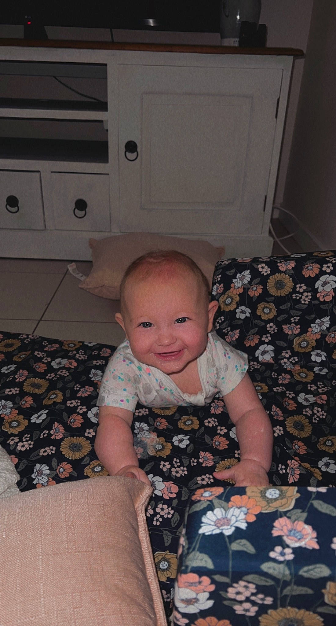 Amara joined the competition — help win amazing prizes! baby, baby_toddler_clothing, cabinetry, carpet, child, comfort, door, drawer, floor, flooring, joy, lap, pattern, person, room, sitting, sleeve, smile, sock, t_shirt