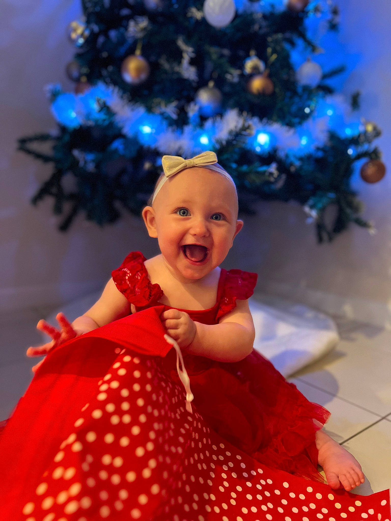 Amara joined the competition — help win amazing prizes! baby_toddler_clothing, child, christmas, christmas_decoration, christmas_ornament, christmas_tree, electric_blue, event, fun, happy, holiday, holiday_ornament, light, magenta, one_piece_garment, ornament, pattern, person, smile, toddler