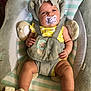 Paisley is registered to the contest to win money with this photo: baby, infant, pacifier, headband, yellow_clothing, baby_seat, straps, soft_cushions, footwear, polka_dots, cute, child, indoors, portrait, plush, comfortable, sitting, toddler, person, baby_accessories