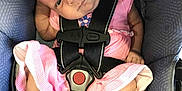 Paisley joined the competition — help win amazing prizes! baby, infant, car_seat, pink_dress, booties, fur_trim, seatbelt, child, cute, looking_sideways, strapped_in, indoors, closeup, soft_lighting, small_hands, head_tilt, fabric_texture, safety_harness, comfort, expression