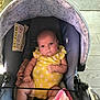 Paisley is registered to the contest to win money with this photo: baby, infant, car_seat, yellow_onesie, polka_dot, blanket, child, seat_belt, indoors, person, cute, newborn, soft, pink_blanket, expression, sitting, face, head, plush, comfort