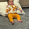 baby, child, infant, yellow_leggings, flower_print, headband, pillow, carpet, floor, cute, indoors, resting, clothing, sitting, person, portrait, toddler, headwear, home, cozy