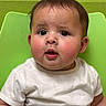 baby, child, curious, cute, expression, eyes, face, green_chair, head, indoors, infant, mouth, person, portrait, rosy_cheeks, short_hair, sitting, skin, white_shirt, young_child