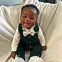 Amaree is registered to the contest to win money with this photo: baby, blanket, bow_tie, child, cozy, curly_hair, cute, fashion, green_suit, happy, indoors, infant, playful, portrait, sitting, small_shoes, smiling, soft_texture, white_shirt, white_shoes