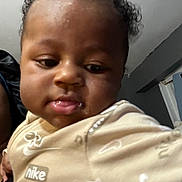 Amaree is registered to the contest to win money with this photo: apparel, baby, babywear, child, childhood, closeup, clothing, curly_hair, cute, expression, face, head, human, indoor, infant, nike, person, portrait, skin, young