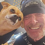 Girlfriend is registered to the contest to win money with this photo: animal, brown_dog, cap, casual, chair, closeup, companion, dog, face, friendship, happy, headwear, indoor, light, man, person, pet, portrait, selfie, smile