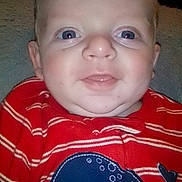 Kelly is registered to the contest to win money with this photo: baby, child, infant, portrait, smiling, happy, face, eyes, red_outfit, striped_clothing, whale, animal_design, sitting, indoor, couch, close_up, flash_photography, short_hair, cute, family_photo