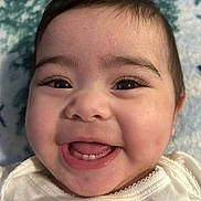 Ana is registered to the contest to win money with this photo: baby, smiling, close_up, face, infant, happy, cute, teeth, eyes, skin, mouth, tongue, clothing, white, blanket, soft, portrait, child, young, expression