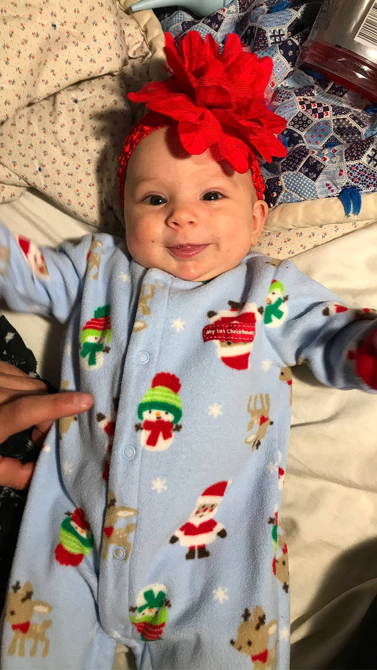 Phoenyx is registered to the contest to win money with this photo: baby, baby_toddler_clothing, child, costume, dress, event, eye, facial_expression, fun, happy, head, headgear, headwear, human_body, joy, outerwear, person, plant, skin, sleeve