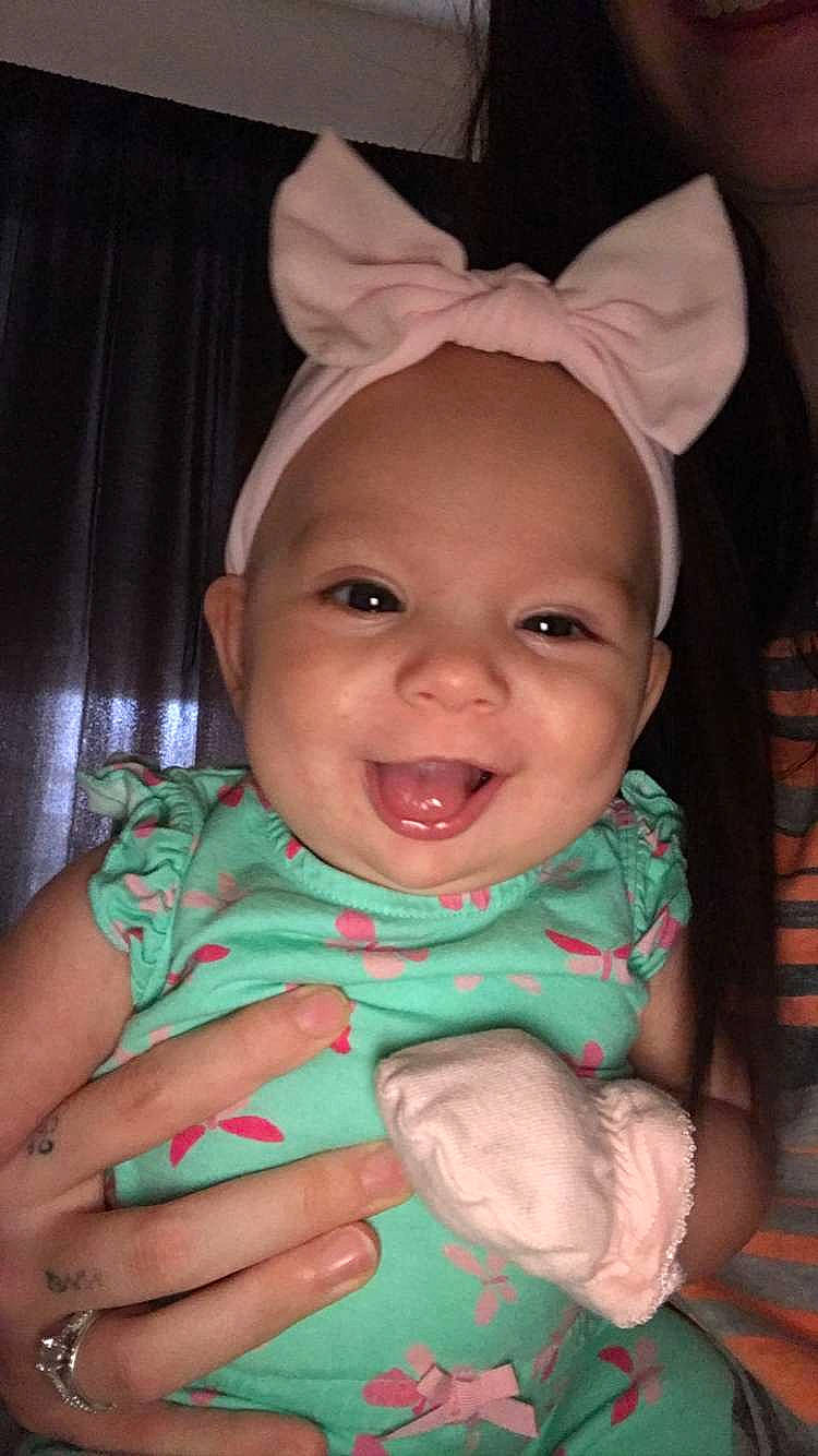 Phoenyx is registered to the contest to win money with this photo: baby, baby_toddler_clothing, cheek, chin, eye, eyebrow, facial_expression, finger, gesture, happy, head, human_body, iris, lip, mouth, nose, person, pink, skin, smile