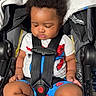 baby, black_hair, car_seat, casual_clothing, child, chubby_legs, curly_hair, cute, indoors, infant, person, portrait, resting, safety, seat_belt, sitting, spiderman_clothing, toddler, white_sock, young_child