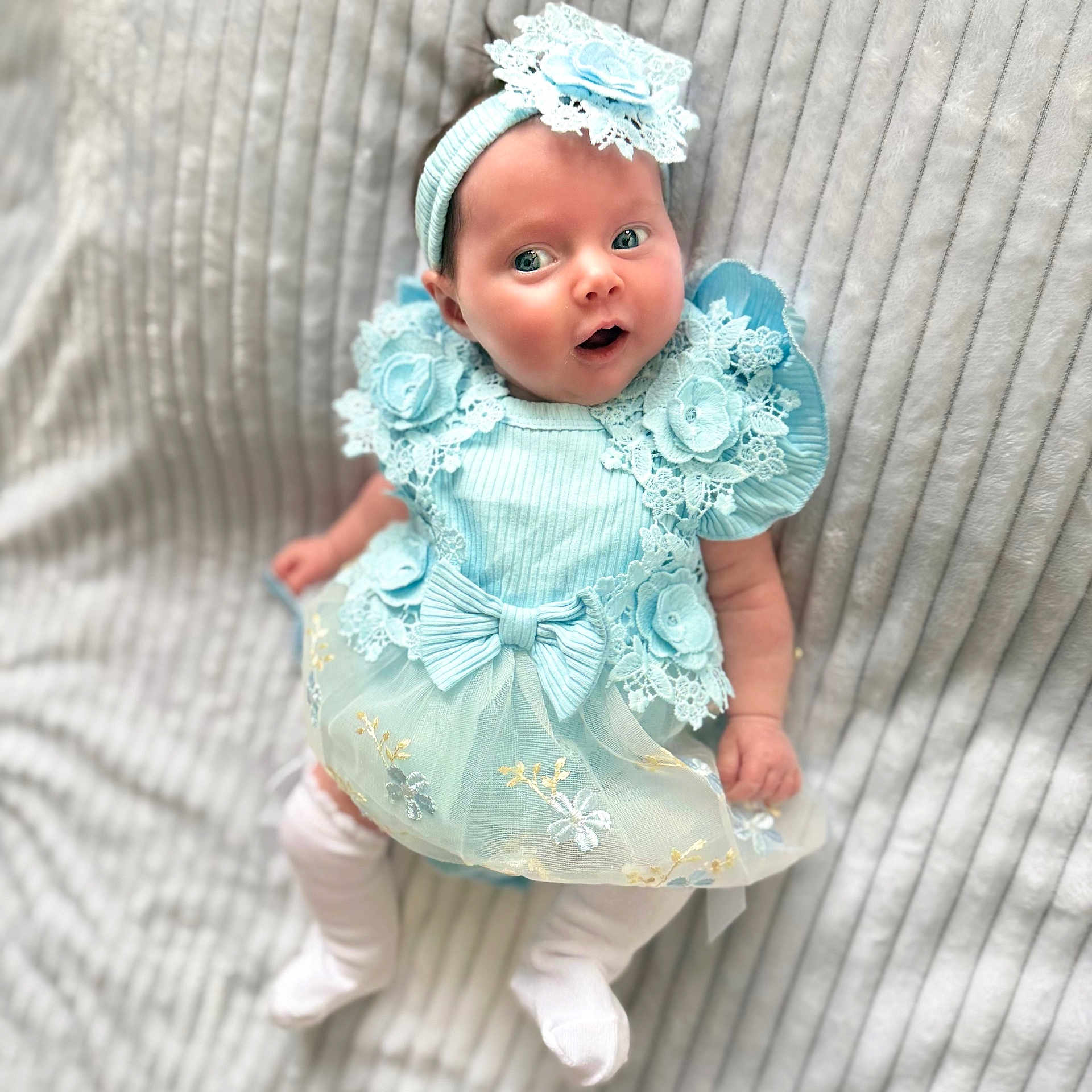 Ruby is registered to the contest to win money with this photo: baby, infant, blue_dress, headband, lace, flower, bow, white_tights, cute, portrait, soft_blanket, lying_down, child, adorable, small_hands, expression, innocent, newborn, fashion, soft_light