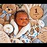 Jj is registered to the contest to win money with this photo: baby, infant, child, portrait, one_month_old, sleepy, face, smiling, blanket, plush_toy, teddy_bear, stuffed_animal, cozy, milestone_photo, wooden_sign, heart, nursery, blue, brown, indoor