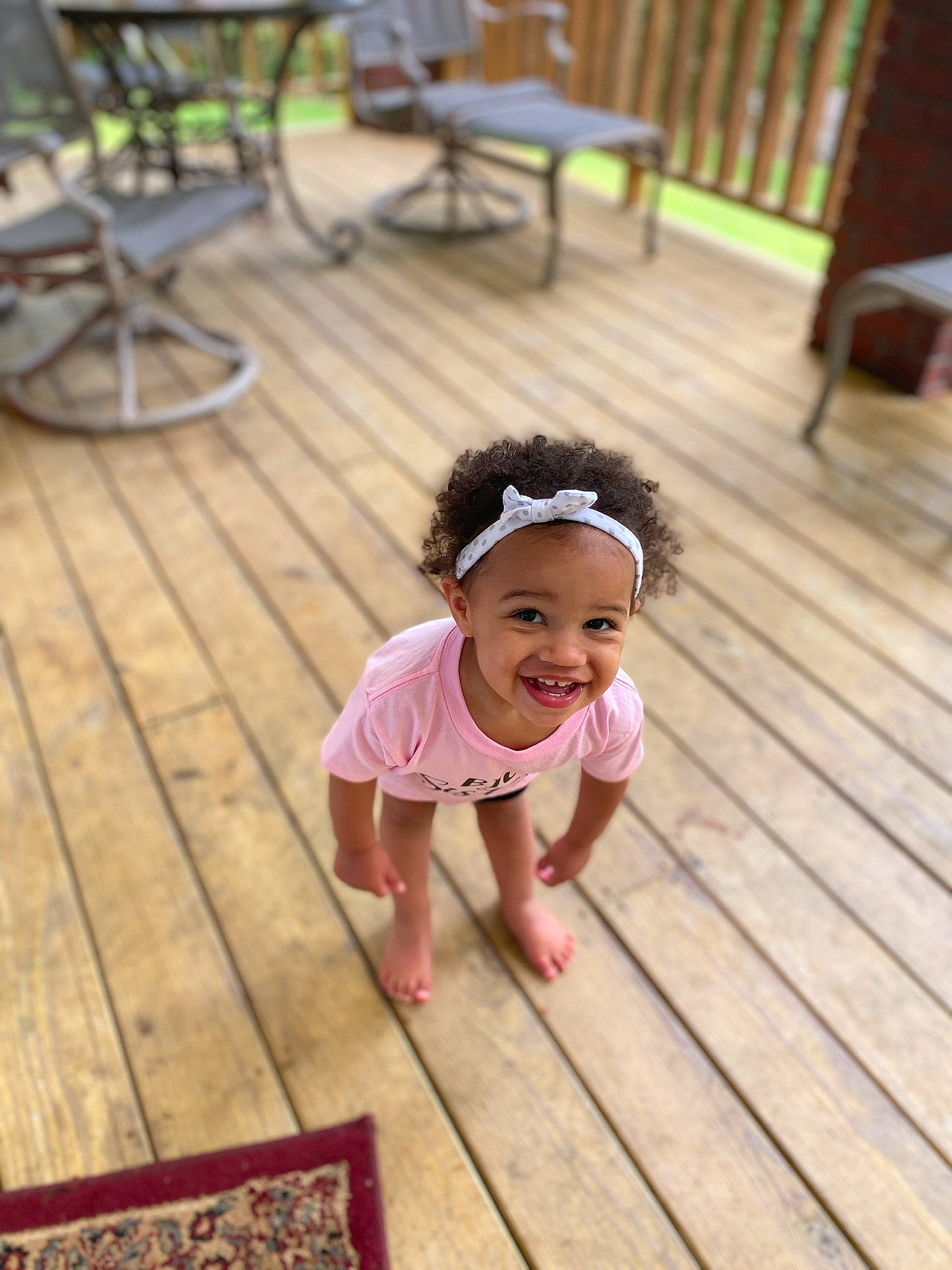 Gracee is registered to the contest to win money with this photo: baby_toddler_clothing, chair, child, clothing, dress, floor, flooring, grass, green, happy, hardwood, head, joy, leisure, pattern, person, plant, skin, smile, toddler