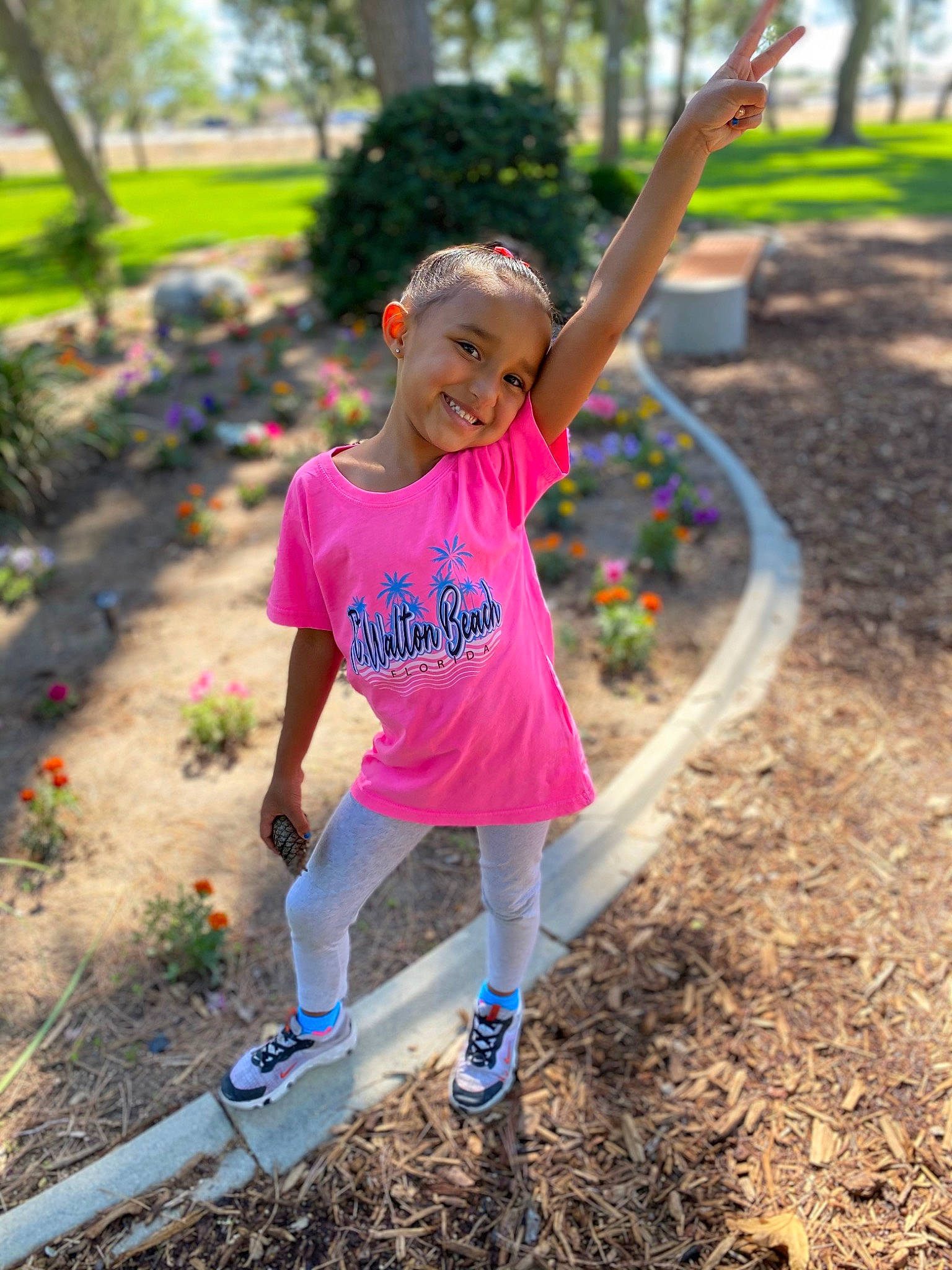 Lilliana is registered to the contest to win money with this photo: botany, footwear, grass, happy, joy, leaf, leg, leisure, outdoor_recreation, people_in_nature, person, pink, plant, shoe, shorts, smile, sneakers, summer, t_shirt, toddler
