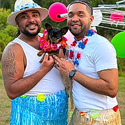 Masha joined the competition — help win amazing prizes! man, dog, outdoor, party, grass_skirt, lei, balloon, smile, tattoo, hat, facial_hair, white_shirt, watch, earring, beard, friendship, celebration, nature, pet, colorful