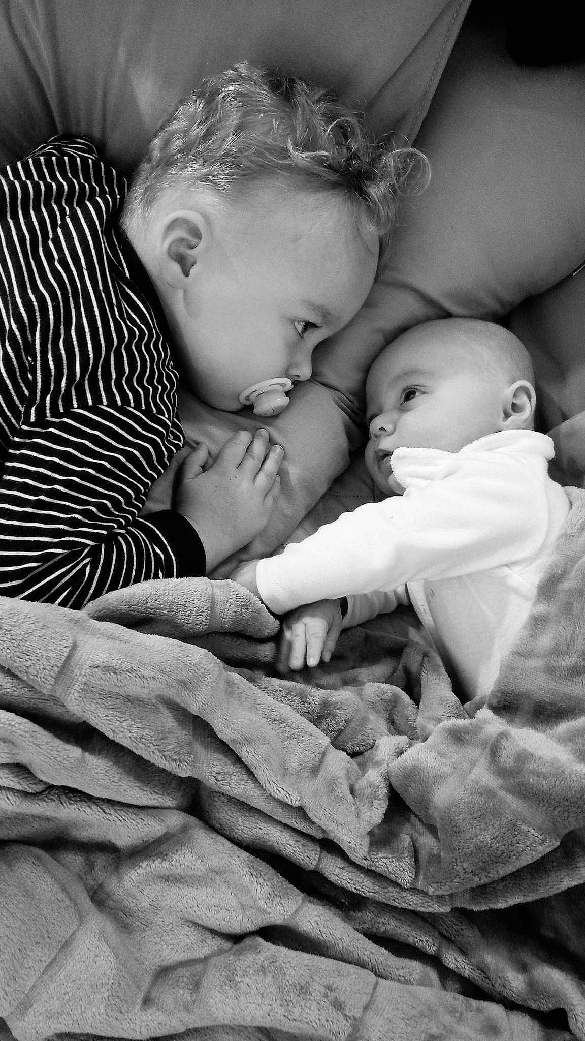 Aaron participe au concours pour gagner de l'argent avec cette photo : arm, baby, black, child, comfort, eye, flash_photography, fun, gesture, grass, happy, head, love, monochrome, monochrome_photography, person, sitting, stock_photography, style, toddler
