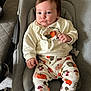 Eloise joined the competition — help win amazing prizes! baby, infant, child, sitting, clothing, sweatshirt, pants, pumpkin, pattern, face, blue_eyes, hair, cushion, seat, dog, pet, indoor, cute, expression, cozy