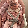 baby, child, pink, high_chair, headband, bow, clothing, sitting, indoor, straps, footwear, cute, expression, face, person, soft_texture, pajamas, floor, furniture, infant