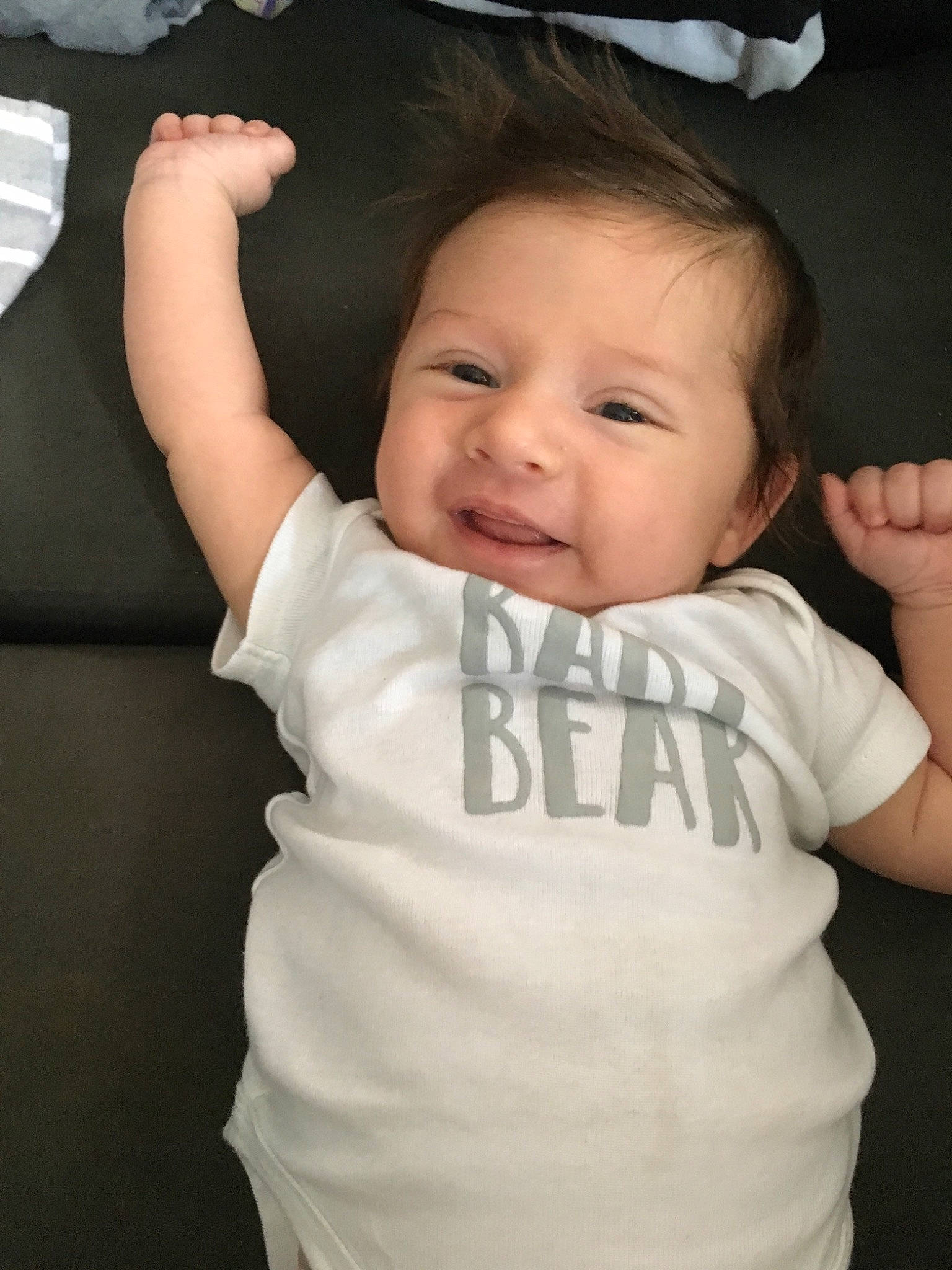 Oliver is registered to the contest to win money with this photo: arm, baby, baby_toddler_clothing, cheek, child, face, facial_expression, finger, gesture, hand, head, mouth, neck, person, skin, smile, thumb, toddler