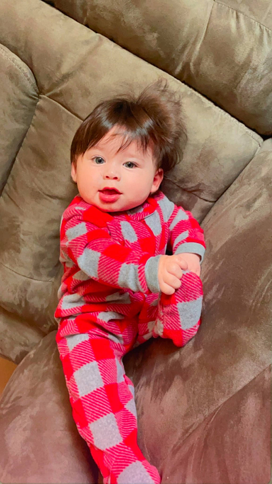 Joseph is registered to the contest to win money with this photo: baby, baby_toddler_clothing, child, collar, comfort, couch, eye, face, finger, happy, head, linens, pattern, person, pink, plaid, sitting, skin, sleeve, tartan